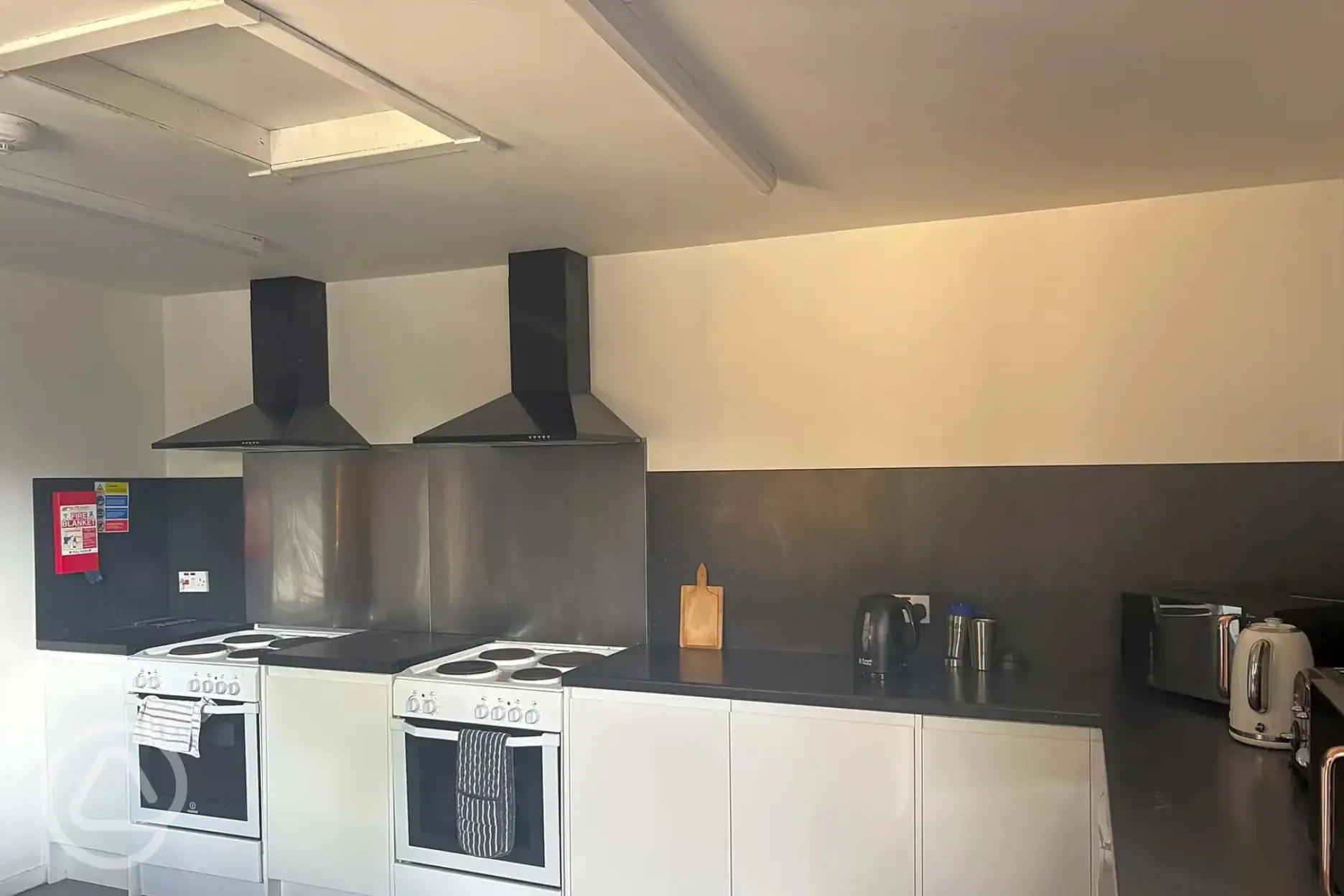 Communal kitchen with ovens, hobs, and cooking equipment Communal kitchen with ovens, hobs, and cooking equipment