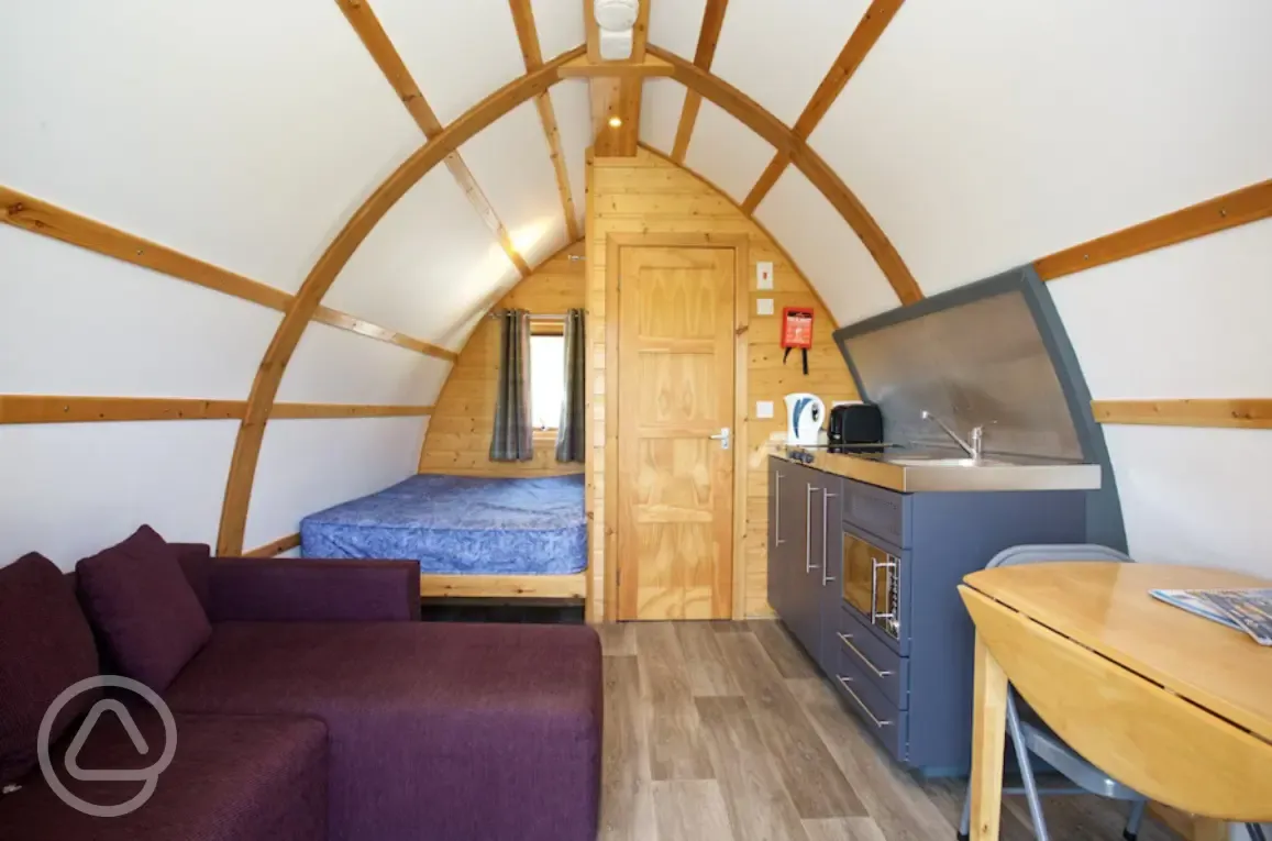 Premium ensuite glamping pod interior with a double bed Premium ensuite glamping pod interior with a double bed