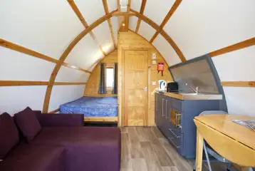 Premium ensuite glamping pod interior with a double bed Premium ensuite glamping pod interior with a double bed