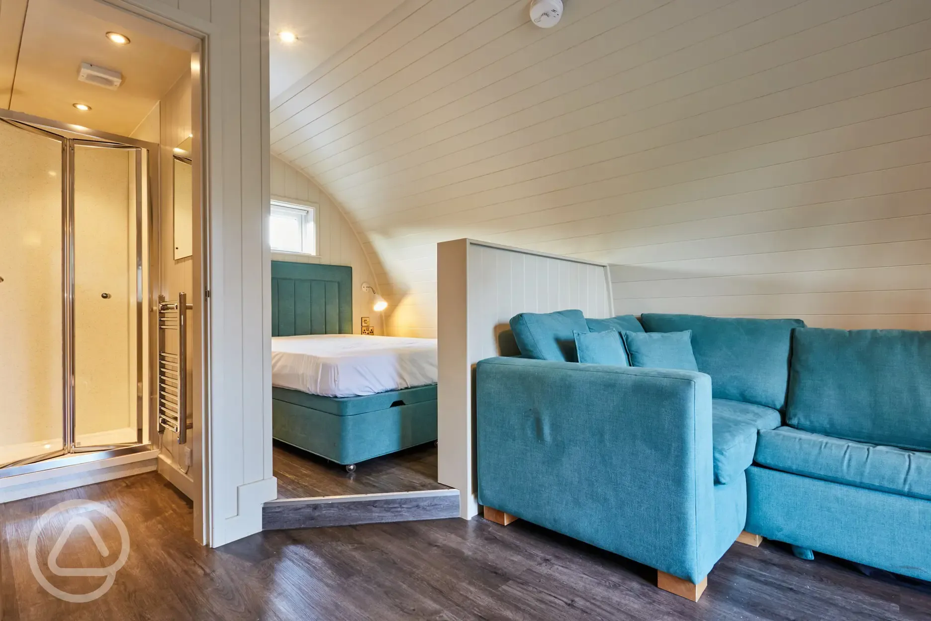 Superior ensuite glamping pod interior with double bed and sofa Superior ensuite glamping pod interior with double bed and sofa