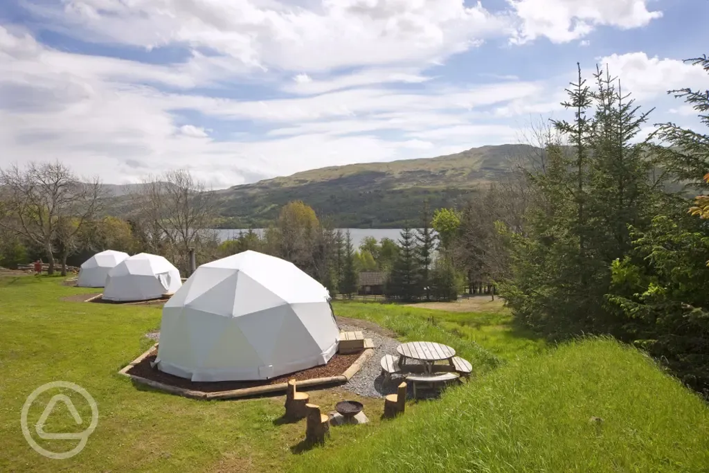 Camping domes surrounded by woodland and forest trees Camping domes surrounded by woodland and forest trees