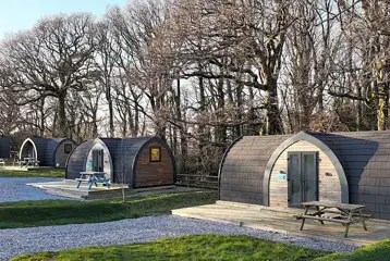 Orchard pods with small decking areas and picnic benches Orchard pods with small decking areas and picnic benches