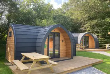 Orchard pods with small decking areas and picnic benches Orchard pods with small decking areas and picnic benches