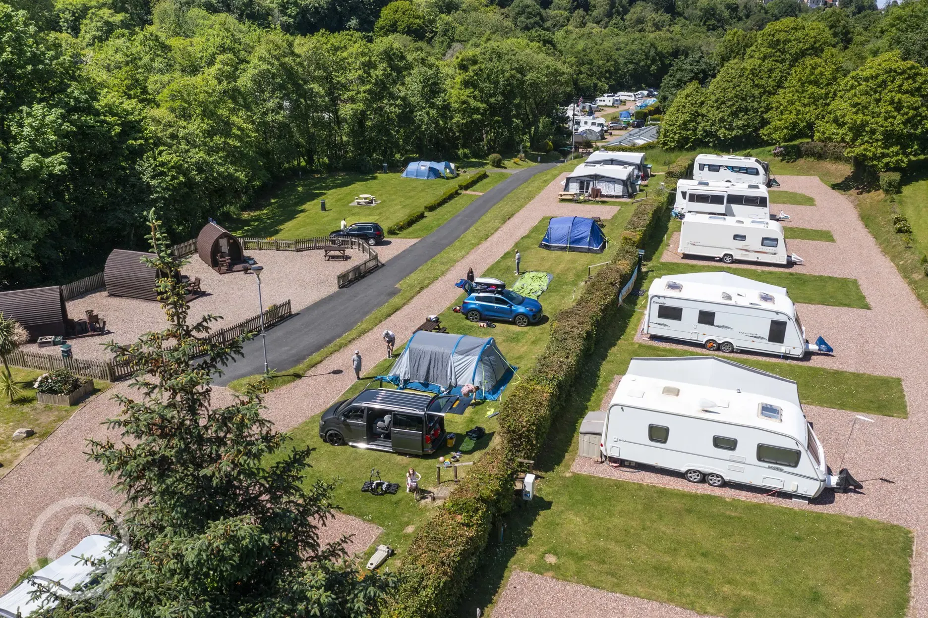 Aerial view of the grass and hardstanding pitches and camping pods