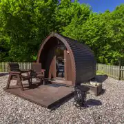 Camping pod with decking, chairs, and a fire pit Camping pod with decking, chairs, and a fire pit