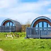 Silver glamping pods exterior with decking and outdoor seating