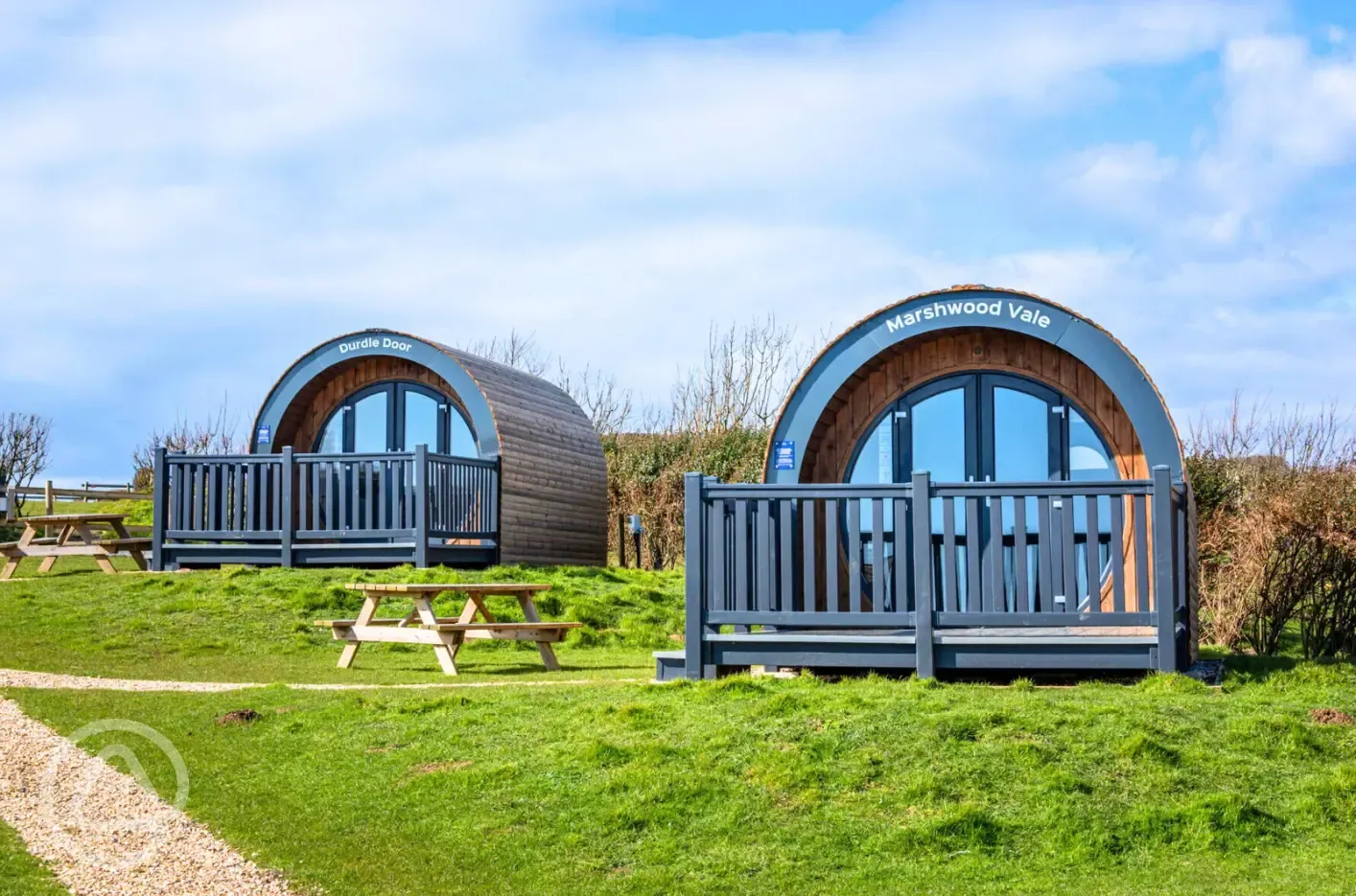 Silver glamping pods exterior with decking and outdoor seating
