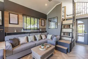 Ensuite glamping cabin interior with kitchen, sofa bed, king size and twin beds Ensuite glamping cabin interior with kitchen, sofa bed, king size and twin beds