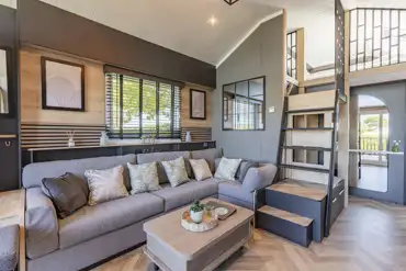 Ensuite glamping cabin interior with kitchen, sofa bed, king size and twin beds