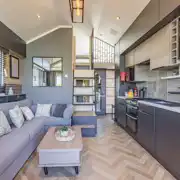 Ensuite glamping cabin interior with kitchen, sofa bed, king size and twin beds Ensuite glamping cabin interior with kitchen, sofa bed, king size and twin beds