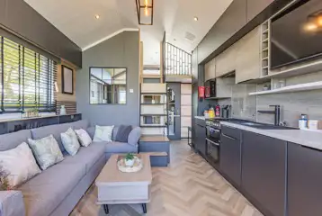 Ensuite glamping cabin interior with kitchen, sofa bed, king size and twin beds Ensuite glamping cabin interior with kitchen, sofa bed, king size and twin beds