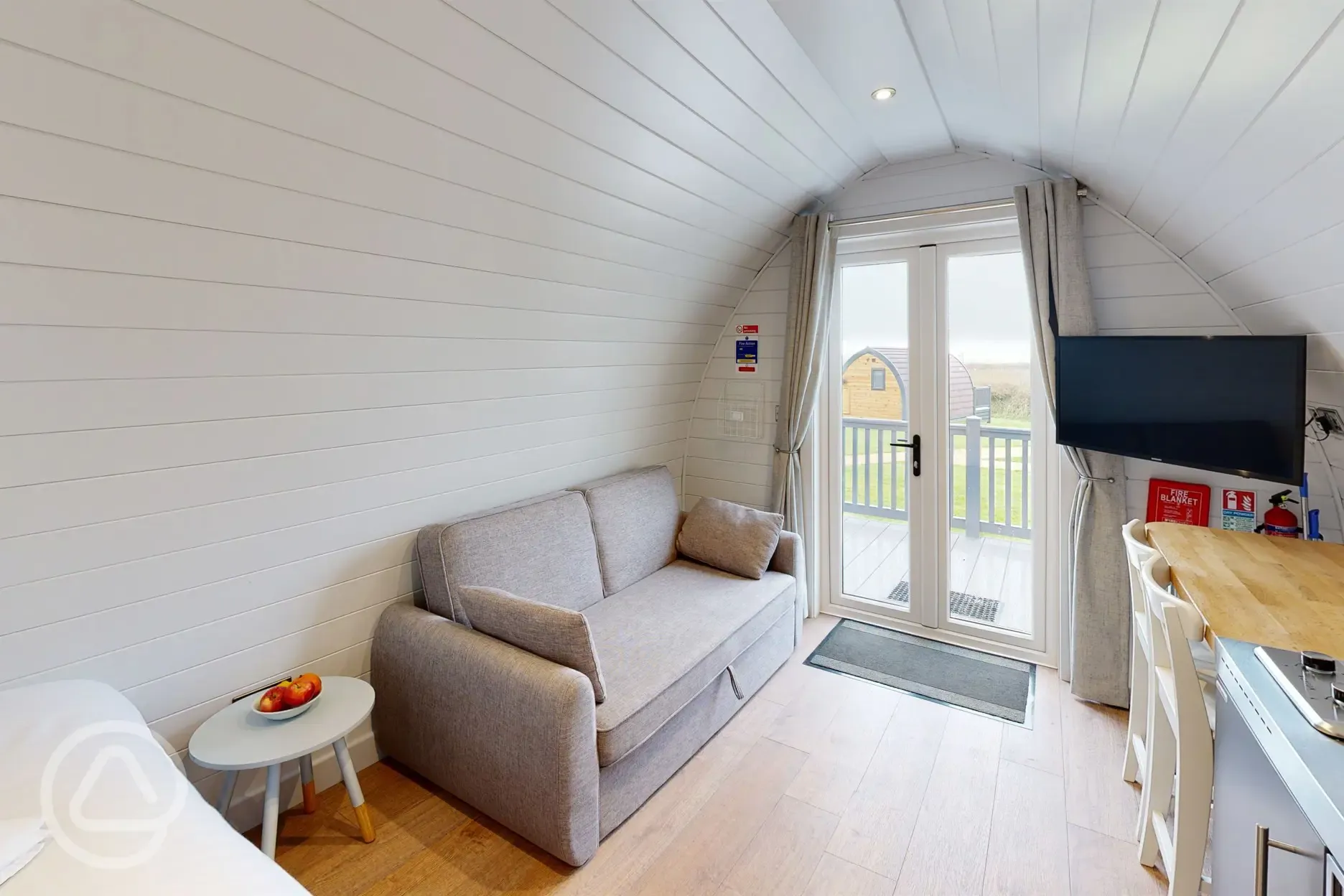 Glamping pod double sofa bed, dining area and TV
