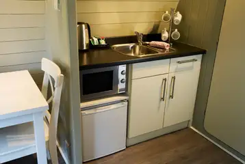 Kitchenette with a kettle, mircrowave, and fridge in the premier pods Kitchenette with a kettle, mircrowave, and fridge in the premier pods