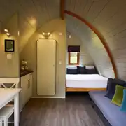 Premier glamping pod interior with a double bed and double sofa bed Premier glamping pod interior with a double bed and double sofa bed