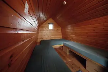 Camping pod interior with bench-style mattresses Camping pod interior with bench-style mattresses