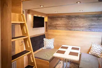 Forest glamping pod dining area with pull down double bed Forest glamping pod dining area with pull down double bed