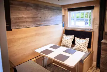 Forest glamping pod dining area with pull down double bed Forest glamping pod dining area with pull down double bed