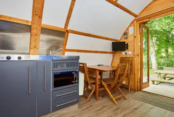 Ensuite glamping pod kitchen, dining area and TV Ensuite glamping pod kitchen, dining area and TV