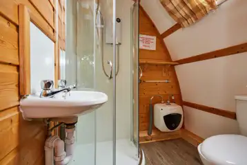 Ensuite glamping pod bathroom with a toilet, sink and shower Ensuite glamping pod bathroom with a toilet, sink and shower