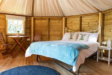 Glamping cabin interior with a double bed (bedding can be hired) Glamping cabin interior with a double bed (bedding can be hired)