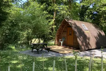 Wooden camping pod with a picnic bench Wooden camping pod with a picnic bench