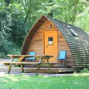 Wooden camping pod with a picnic bench