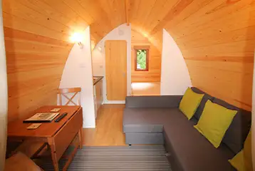 Ensuite glamping pod interior with a double bed and double sofa bed Ensuite glamping pod interior with a double bed and double sofa bed