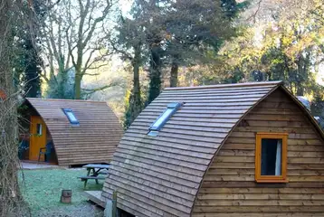 Wooden camping pod with a picnic bench Wooden camping pod with a picnic bench