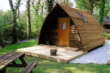 Wooden camping pod with a picnic bench Wooden camping pod with a picnic bench