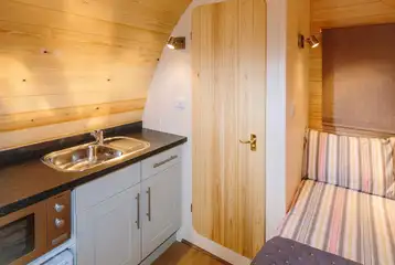 Ensuite pod bed and kitchen with a fridge, kitchen sink, kettle, microwave Ensuite pod bed and kitchen with a fridge, kitchen sink, kettle, microwave