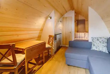 Ensuite glamping pod interior with a double bed and double sofa bed Ensuite glamping pod interior with a double bed and double sofa bed