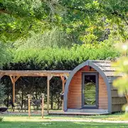 Large camping pods with outdoor furniture and a deck area