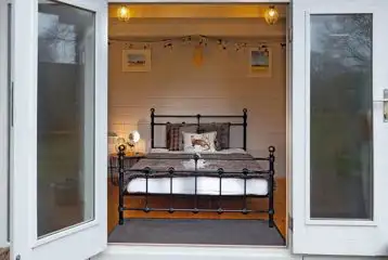 Lodge pod with a double bed and double doors