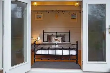 Lodge pod with a double bed and double doors