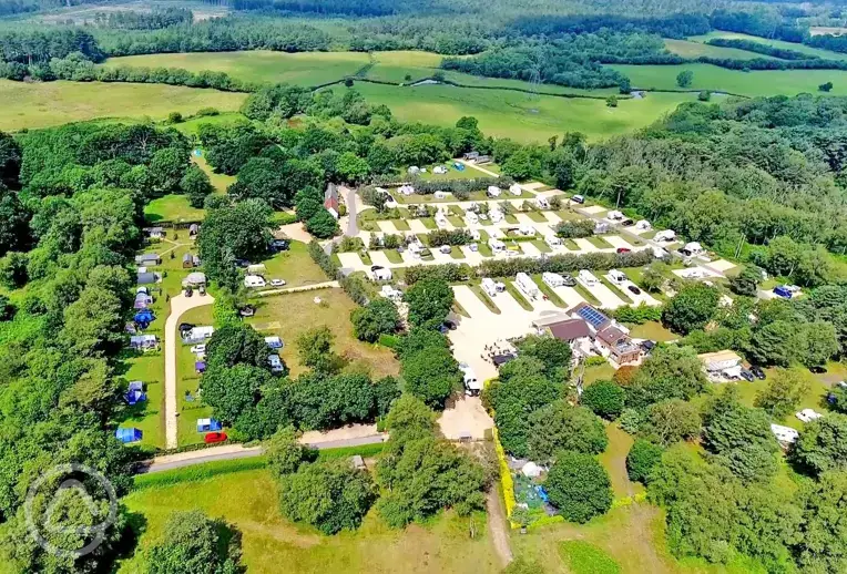 Aerial of Back of Beyond Touring Park surrounded by woodland