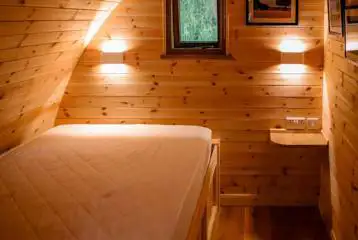 Ensuite glamping pod with hot tub interior with double bed Ensuite glamping pod with hot tub interior with double bed