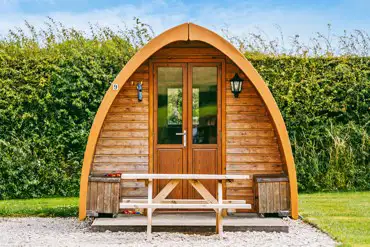 Camping pod exterior with outdoor seating