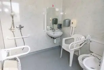 Accessible facilities with toilet, shower, sink, handrails and seating