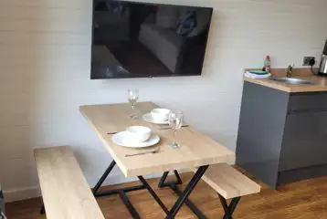 Gwel yr Bae large glamping pod dining table and TV (pet friendly)