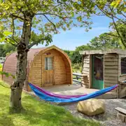 Y Cwtch glamping pod with a hammock and equipped kitchen cabin