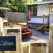 Y Caban garden area with a picnic bench and outdoor kitchen