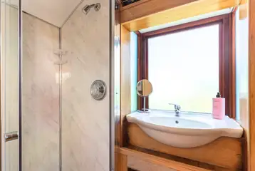 Y Caban ensuite bathroom with a toilet, shower and hand basin Y Caban ensuite bathroom with a toilet, shower and hand basin