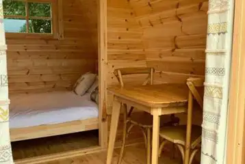 Small camping pod double bed and dining area Small camping pod double bed and dining area