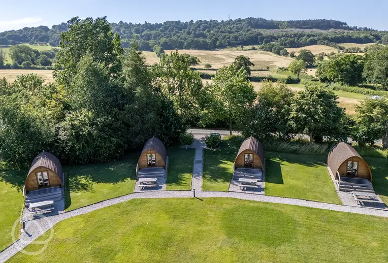 Aerial of the glamping pods with deck area and picnic benches