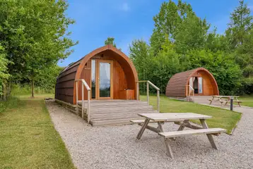Deluxe Mega Pod exterior with stairs and a picnic bench Deluxe Mega Pod exterior with stairs and a picnic bench