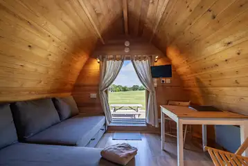 Glamping pod sofa bed, dining area and TV Glamping pod sofa bed, dining area and TV