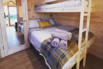 Single bunk and double bed in the Deluxe Mega Pod Single bunk and double bed in the Deluxe Mega Pod