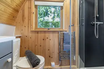 Five person glamping pod bathroom with a toilet and shower Five person glamping pod bathroom with a toilet and shower