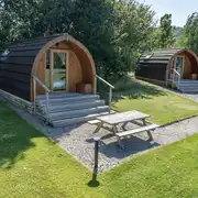 Glamping pods with adjacent grass areas
