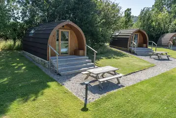 Glamping pods with adjacent grass areas Glamping pods with adjacent grass areas